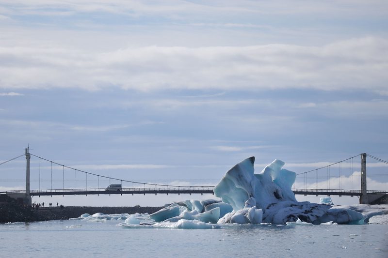 Icebergs drifting under a bridge at the glacier lagoon